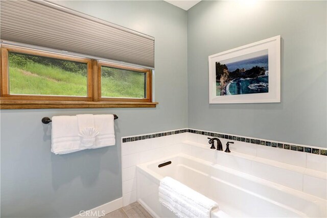 bathroom featuring tile patterned flooring and a tub