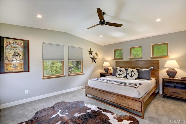 bedroom with ceiling fan, light colored carpet, and lofted ceiling