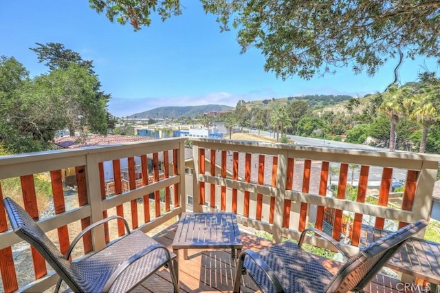 wooden deck with a mountain view