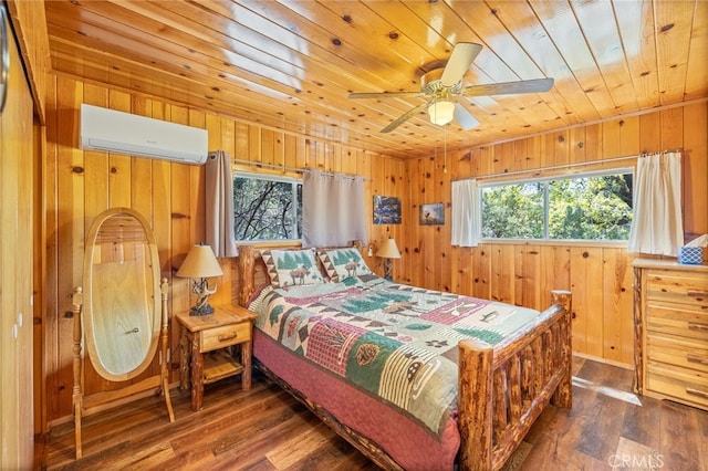 bedroom featuring wood walls, dark wood-type flooring, a wall unit AC, and multiple windows