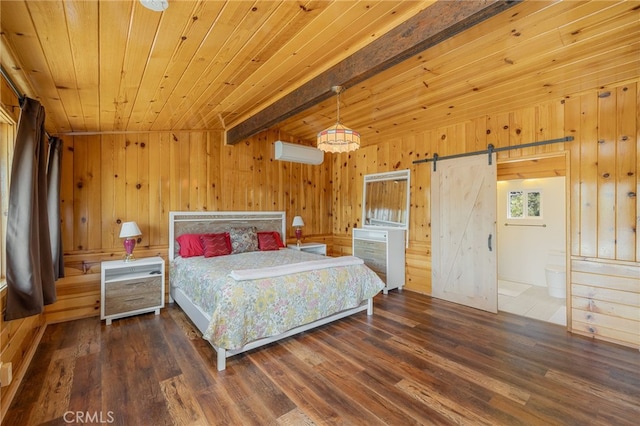 bedroom featuring wooden walls, a barn door, dark hardwood / wood-style flooring, and a wall unit AC