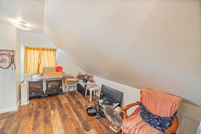 additional living space with dark hardwood / wood-style flooring and lofted ceiling