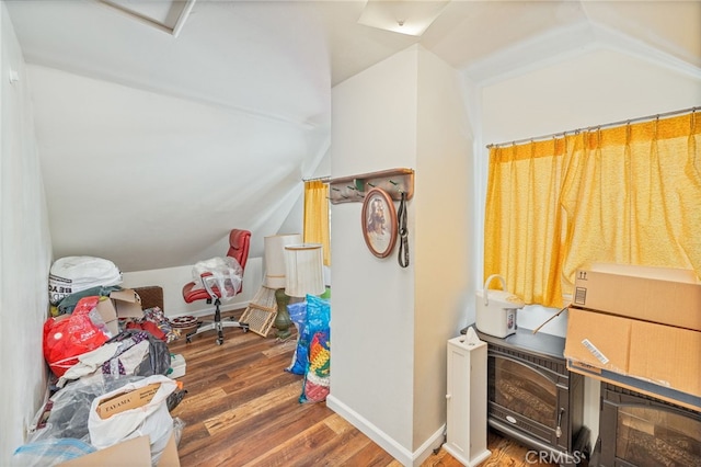 bonus room with lofted ceiling and dark hardwood / wood-style floors