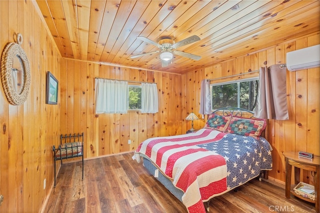 bedroom with dark hardwood / wood-style flooring, multiple windows, and wooden walls