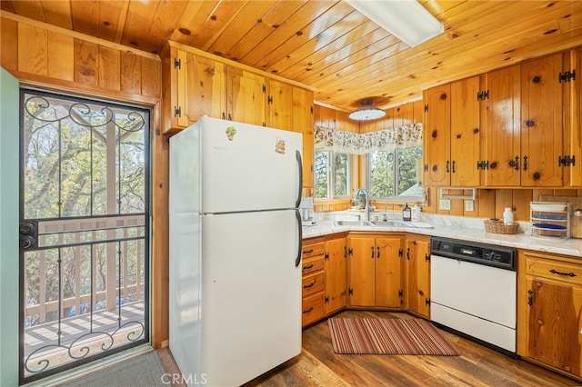 kitchen featuring a wealth of natural light, sink, dark hardwood / wood-style floors, and white appliances