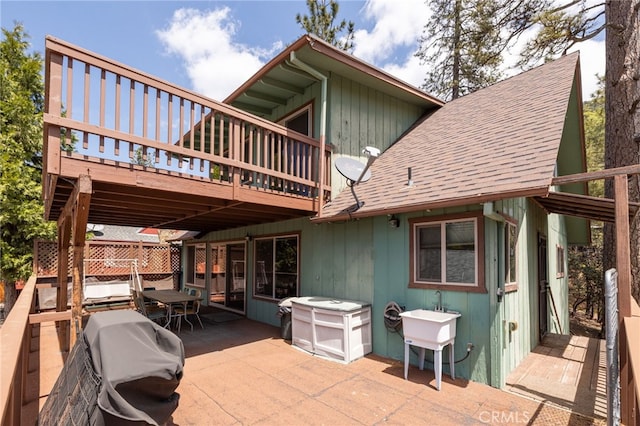 view of patio with a deck, grilling area, and sink