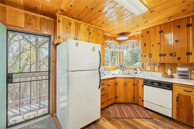 kitchen with white appliances, a wealth of natural light, dark wood-type flooring, and sink