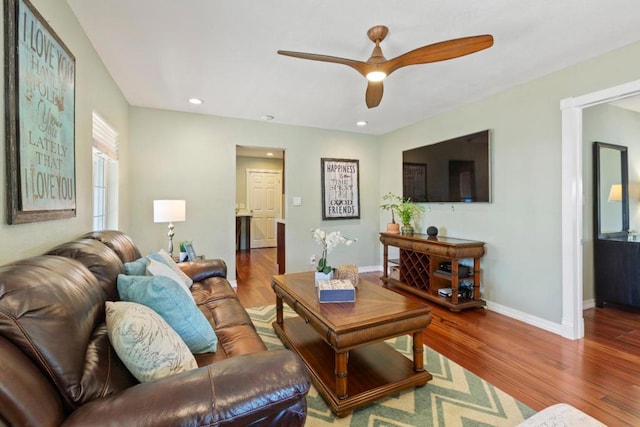 living room with ceiling fan and hardwood / wood-style flooring