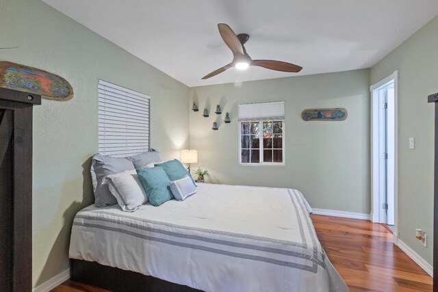 bedroom with wood-type flooring and ceiling fan