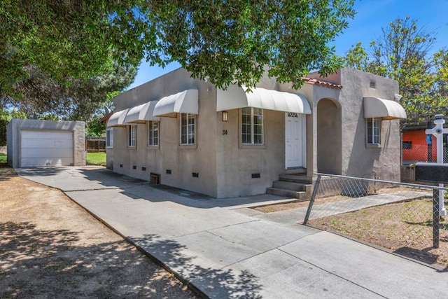 view of front facade featuring a garage and an outdoor structure