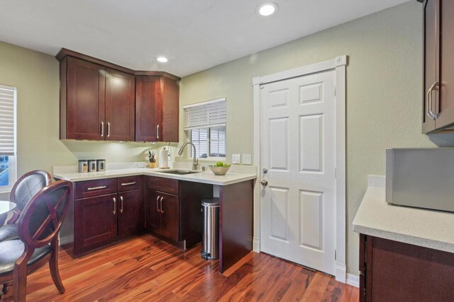 kitchen featuring dark wood-type flooring and sink