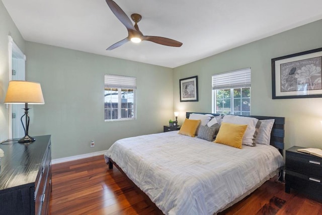 bedroom with dark hardwood / wood-style floors and ceiling fan