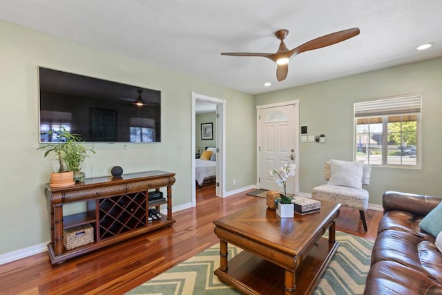 living room featuring ceiling fan and hardwood / wood-style floors