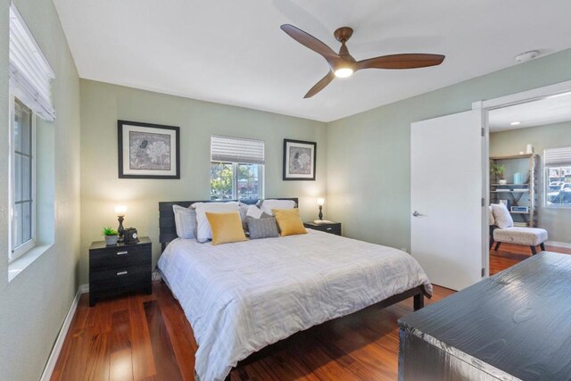 bedroom with dark wood-type flooring and ceiling fan