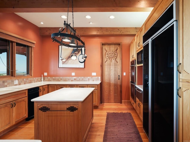 kitchen with light hardwood / wood-style floors, beam ceiling, a kitchen island, and black appliances