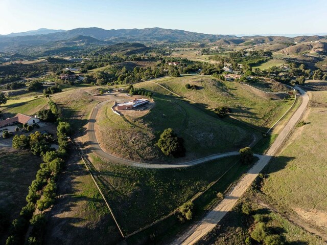 birds eye view of property featuring a mountain view and a rural view