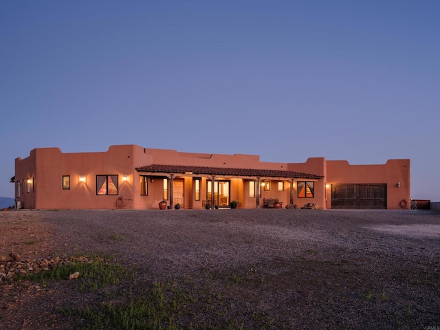 view of back house at dusk