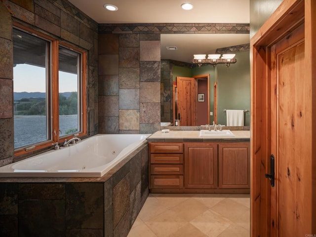 bathroom with tile flooring, tile walls, tiled tub, a water and mountain view, and vanity