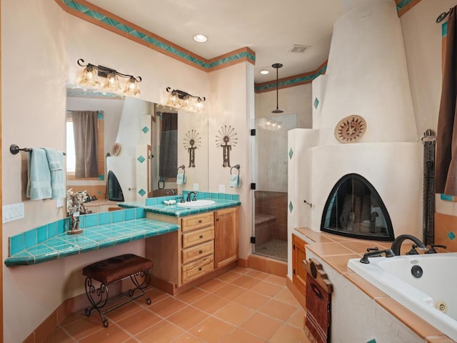 bathroom featuring oversized vanity, separate shower and tub, and tile flooring