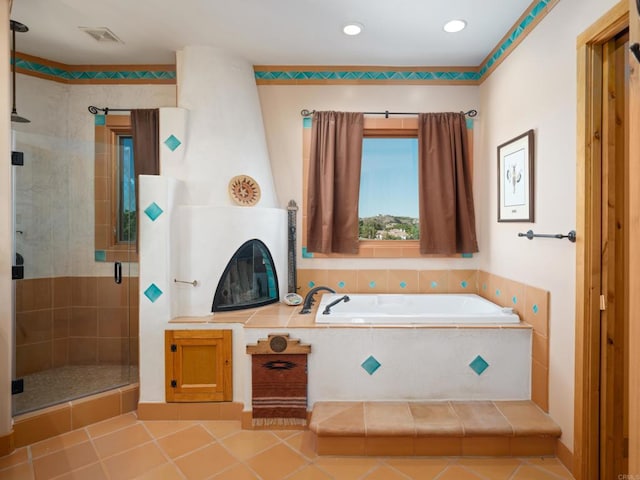 bathroom with tile floors and shower with separate bathtub