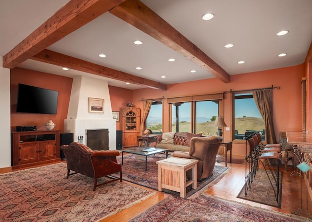 living room with wood-type flooring and beam ceiling