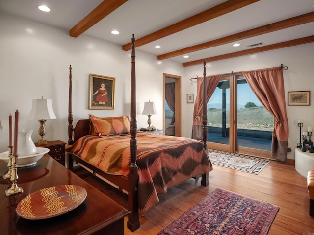 bedroom featuring wood-type flooring, access to outside, and beamed ceiling