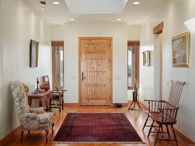 foyer with a wealth of natural light and hardwood / wood-style floors