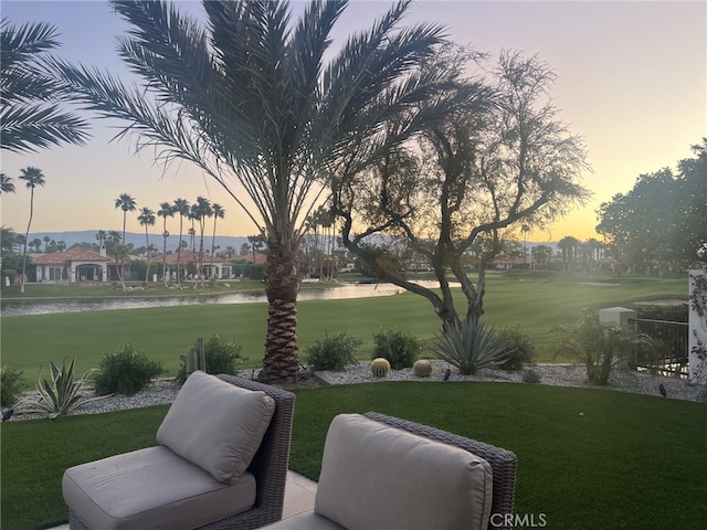 yard at dusk with a water view