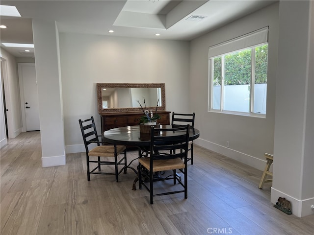 dining space with light hardwood / wood-style flooring