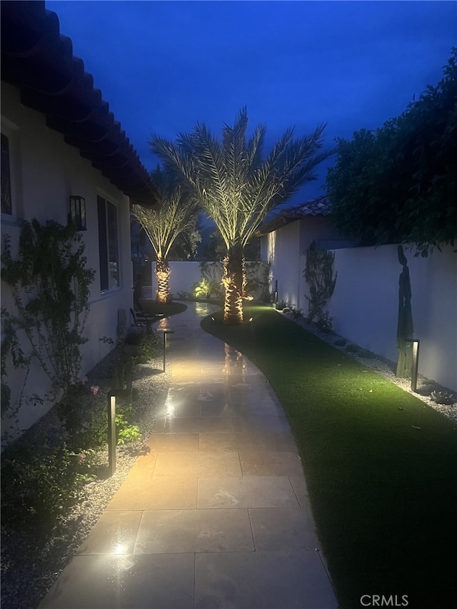 yard at twilight featuring a patio