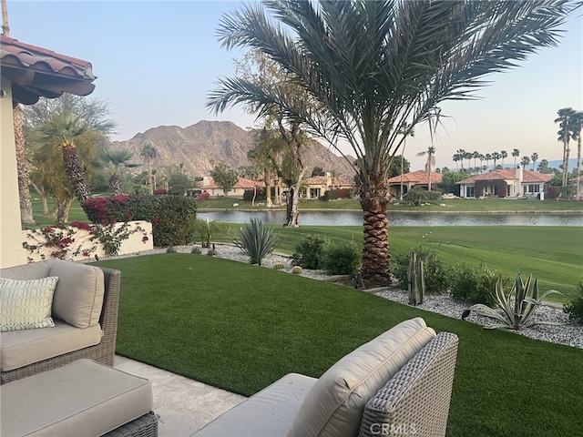 view of yard with an outdoor hangout area and a water and mountain view