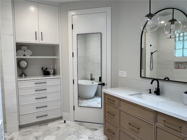 bathroom featuring vanity and shower with separate bathtub