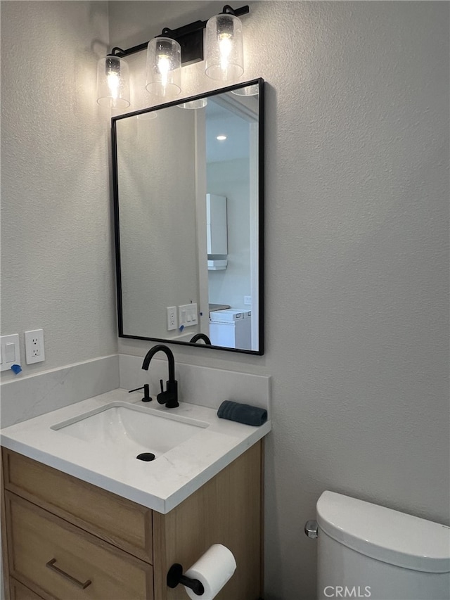 bathroom with toilet and vanity