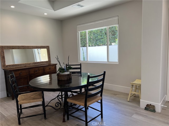 dining space with light hardwood / wood-style flooring