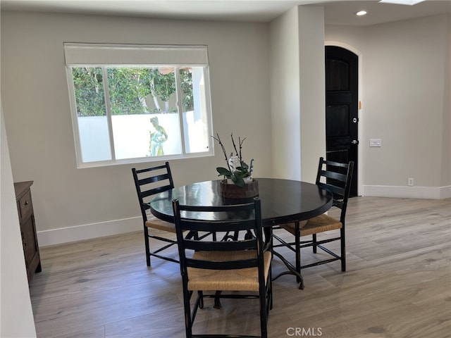 dining space with light hardwood / wood-style floors