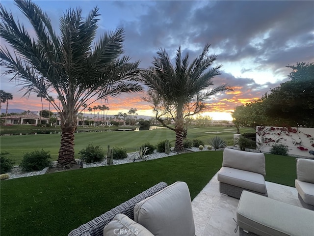 yard at dusk featuring outdoor lounge area