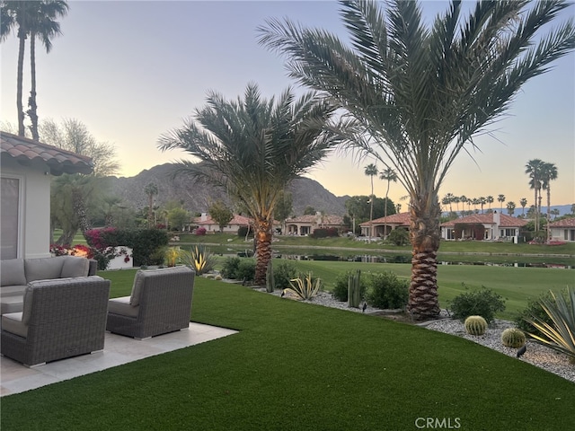 yard at dusk with a mountain view and outdoor lounge area