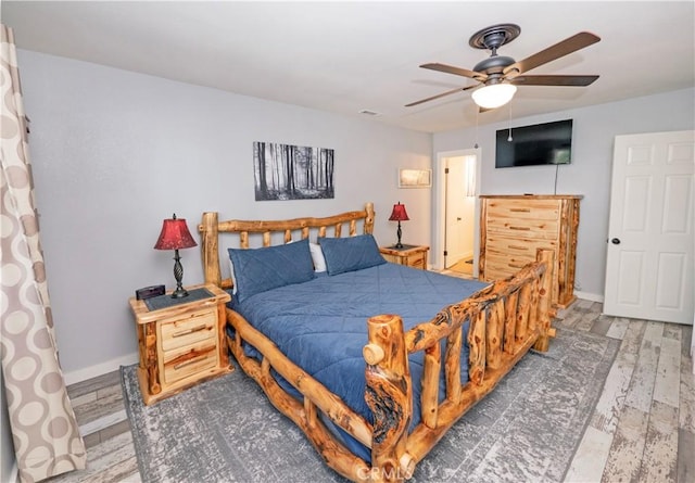 bedroom with hardwood / wood-style floors and ceiling fan