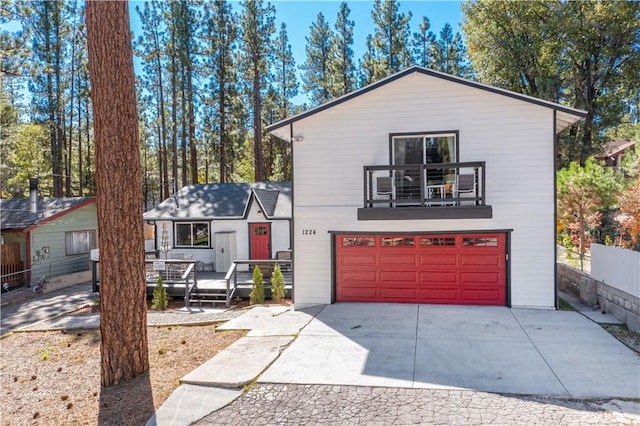 view of front of home featuring a balcony, a garage, and a deck