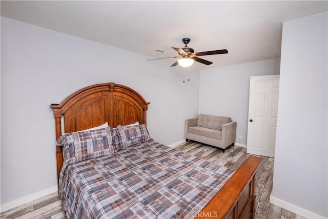 bedroom with ceiling fan and light wood-type flooring