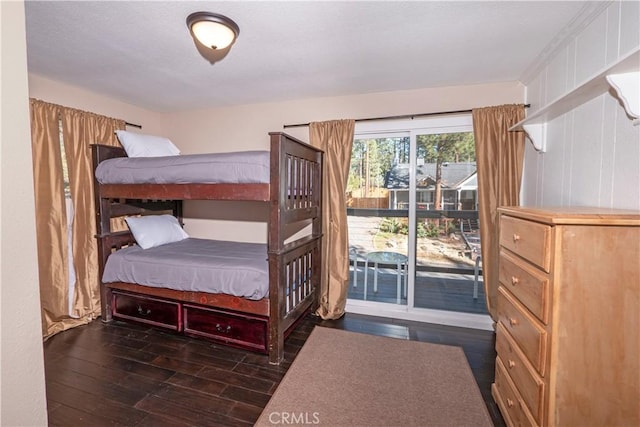 bedroom with dark hardwood / wood-style floors