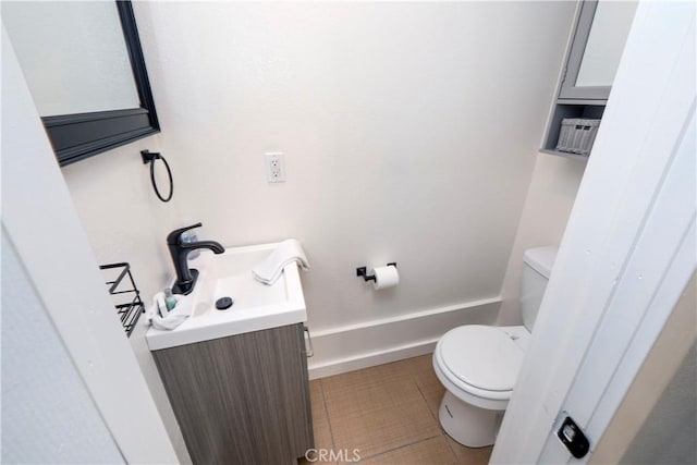 bathroom featuring tile patterned floors, vanity, and toilet