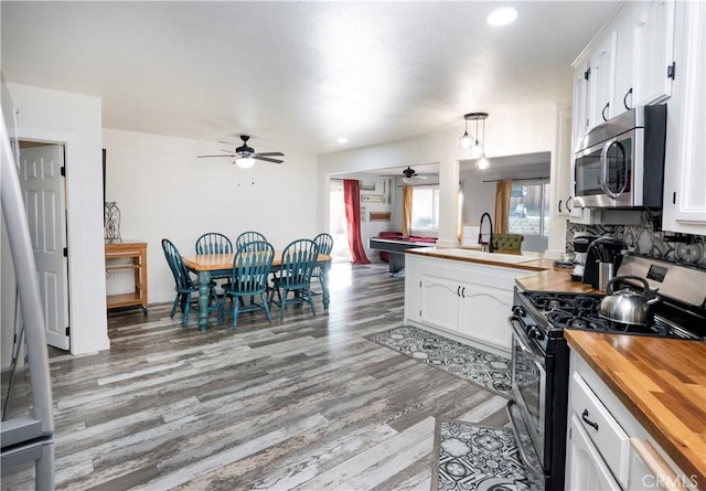 kitchen featuring wood counters, white cabinets, and appliances with stainless steel finishes