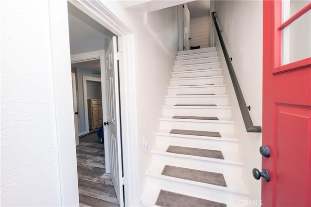 stairway featuring wood-type flooring