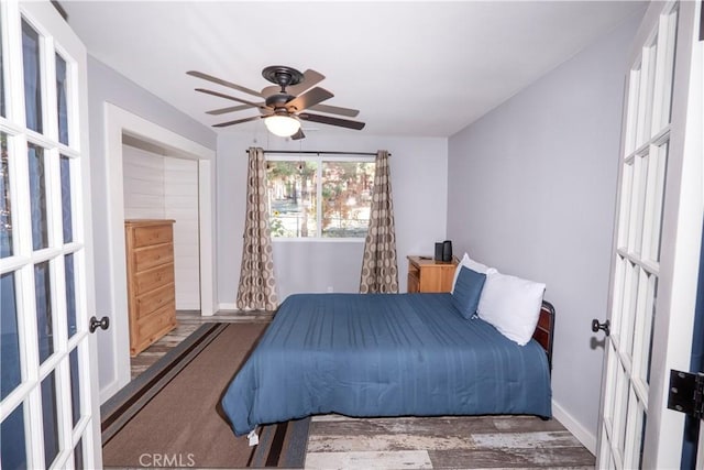 bedroom with wood-type flooring, french doors, and ceiling fan