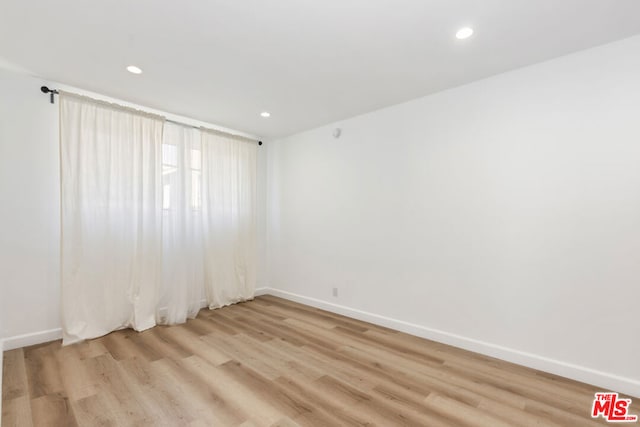 unfurnished room with light wood-type flooring