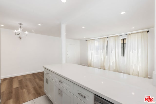 kitchen featuring white cabinetry, dark hardwood / wood-style flooring, and a notable chandelier