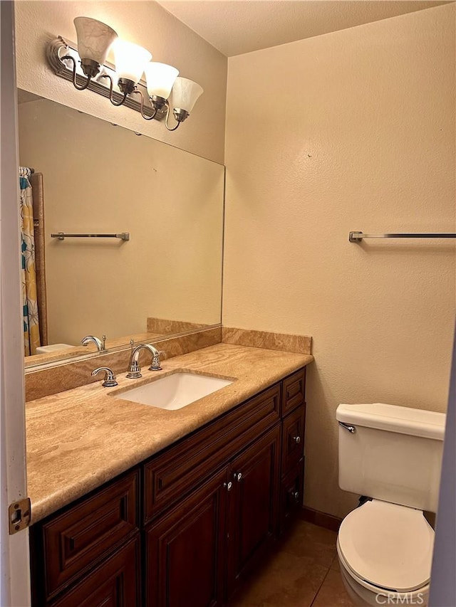 bathroom featuring tile patterned floors, vanity, and toilet