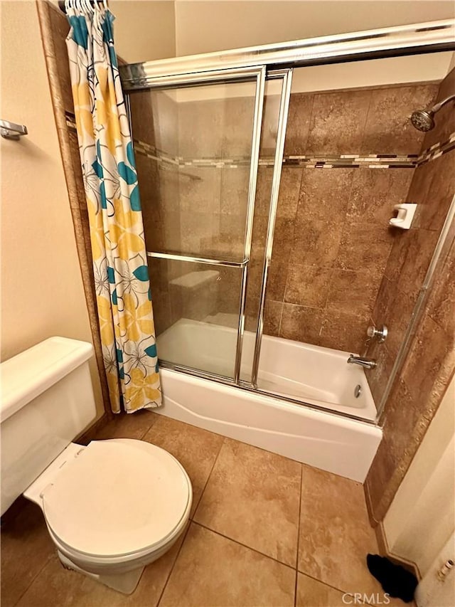 bathroom featuring toilet, shower / tub combo, and tile patterned floors