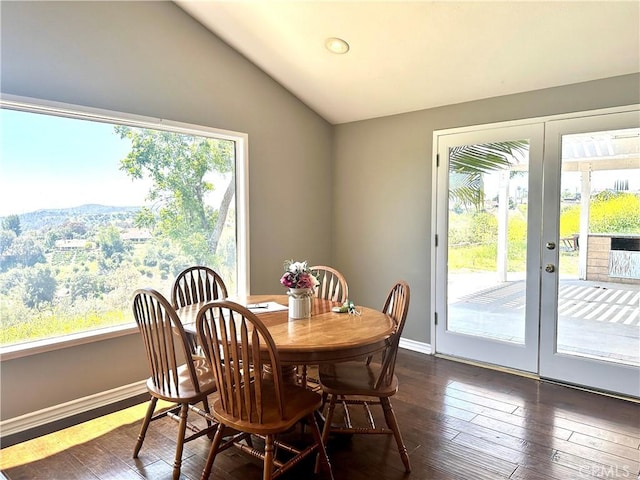 dining room featuring lofted ceiling, french doors, and dark hardwood / wood-style floors